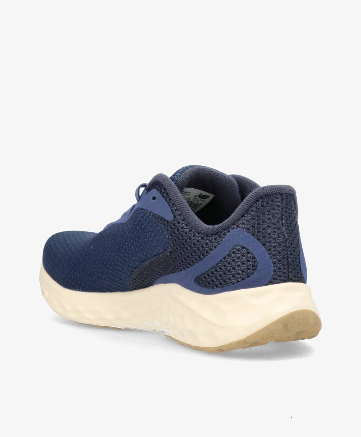 Mørkeblå løbesko med hvid sål og beige hæl, set fra siden.