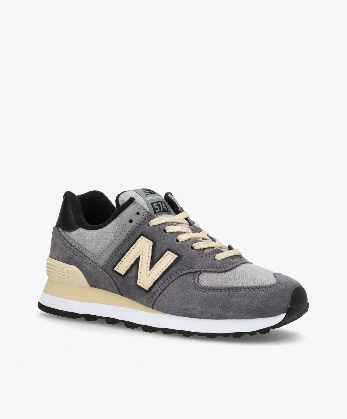 Grå og beige sneaker med sort sål og snørebånd, set fra siden.