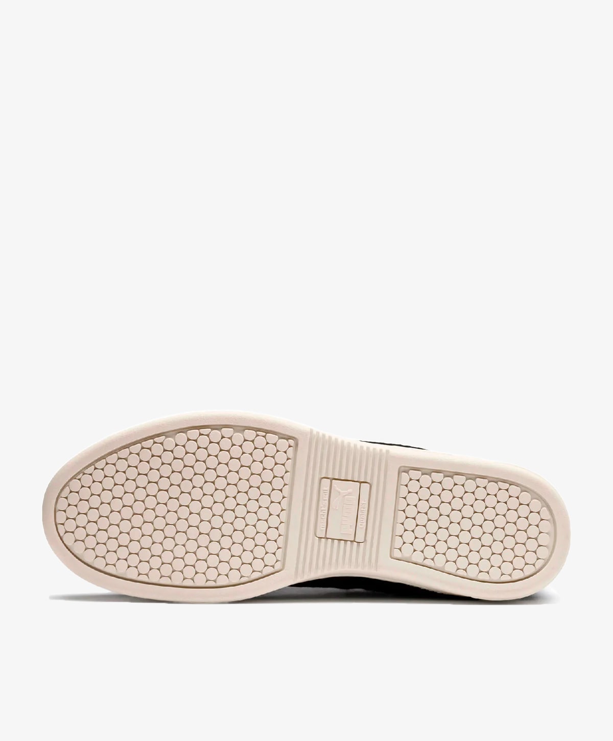 Sål af en sko med et sekskantet mønster i lysebrun farve.