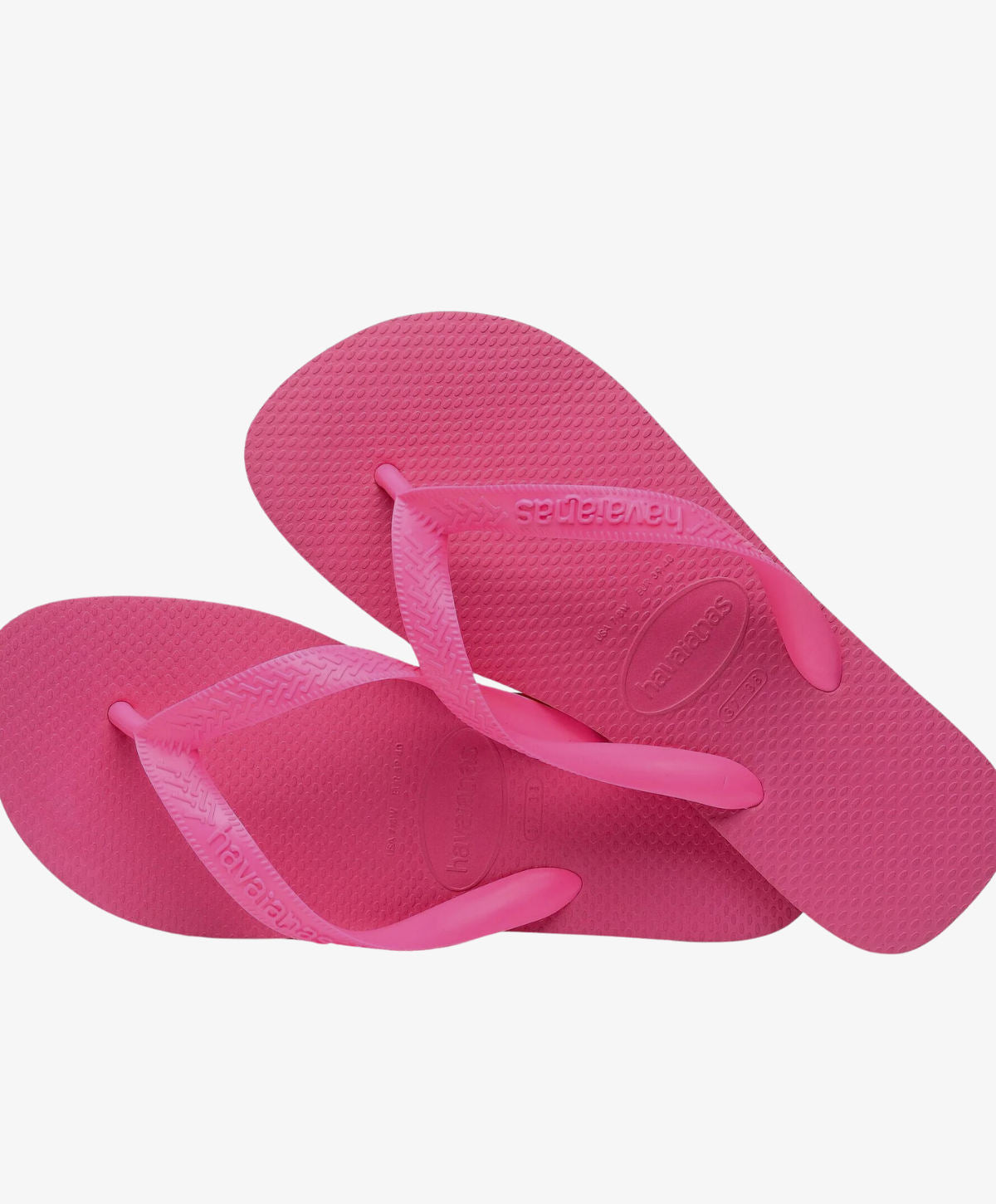 Lyserøde klipklapper med tekstur på sålen og stropperne, set ovenfra.