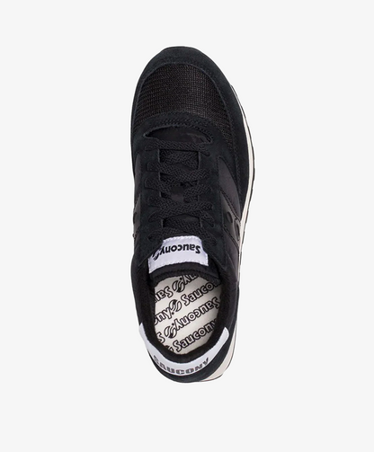 Sort sneaker set fra oven med hvid sål og mærket "Saucony" på indersålen.