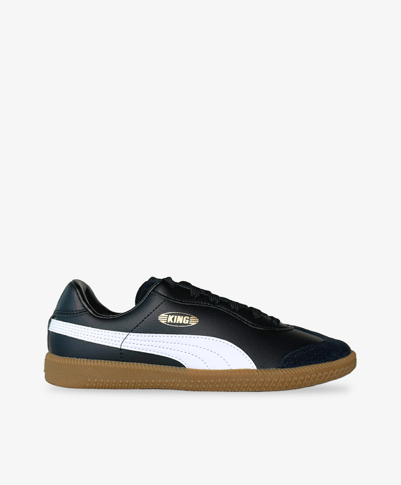 Sorte PUMA sneakers med hvide detaljer og brun bund.