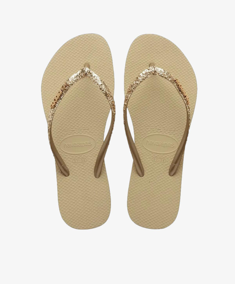 Beige slip-in sandaler med glitrende remme.