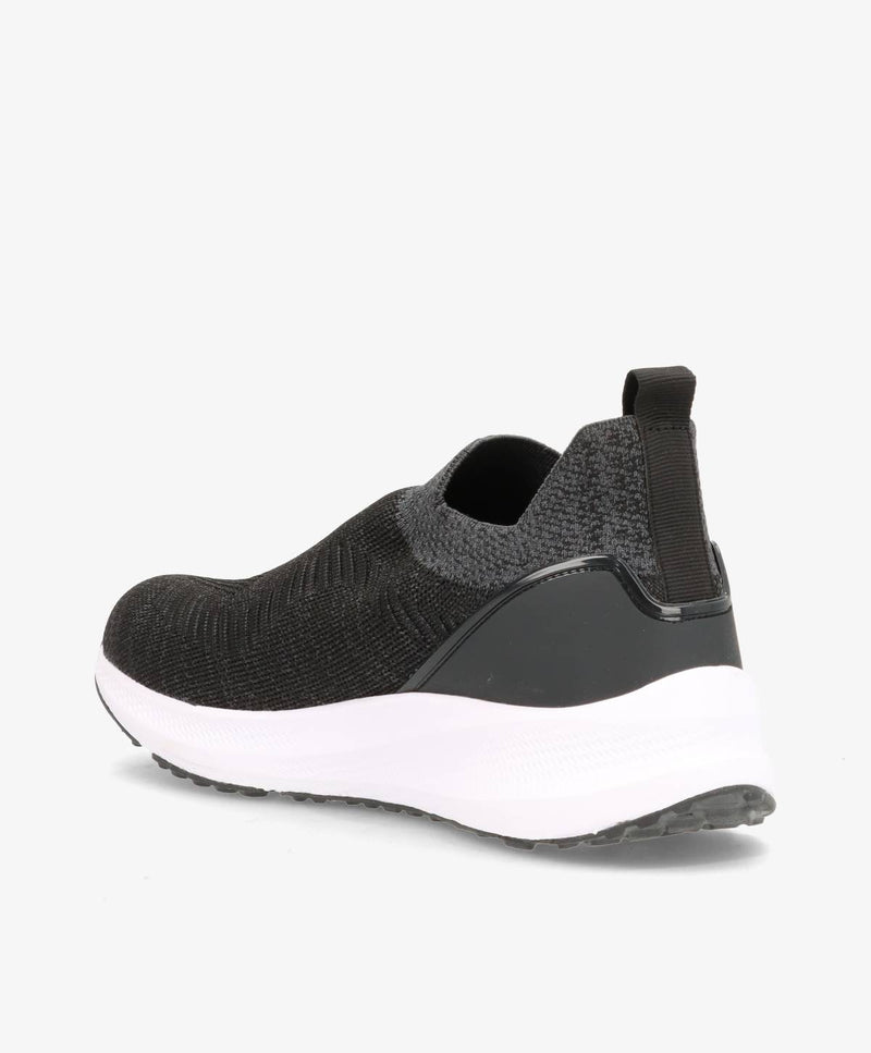 Sort slip-on sko til mænd med hvid sål og elastisk hælstrop.