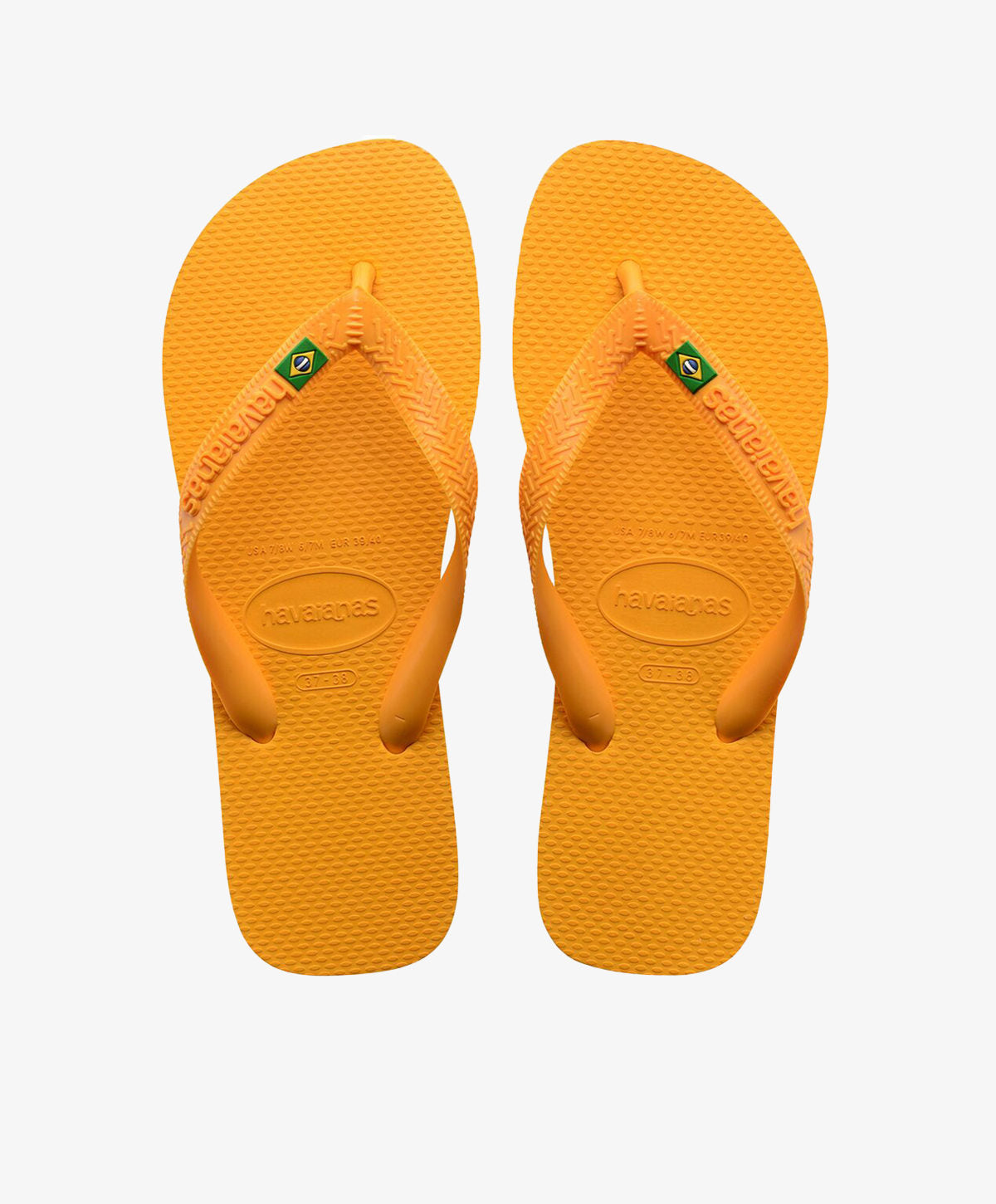 Gule Havaianas slip-ins med logo og brasiliansk flag.